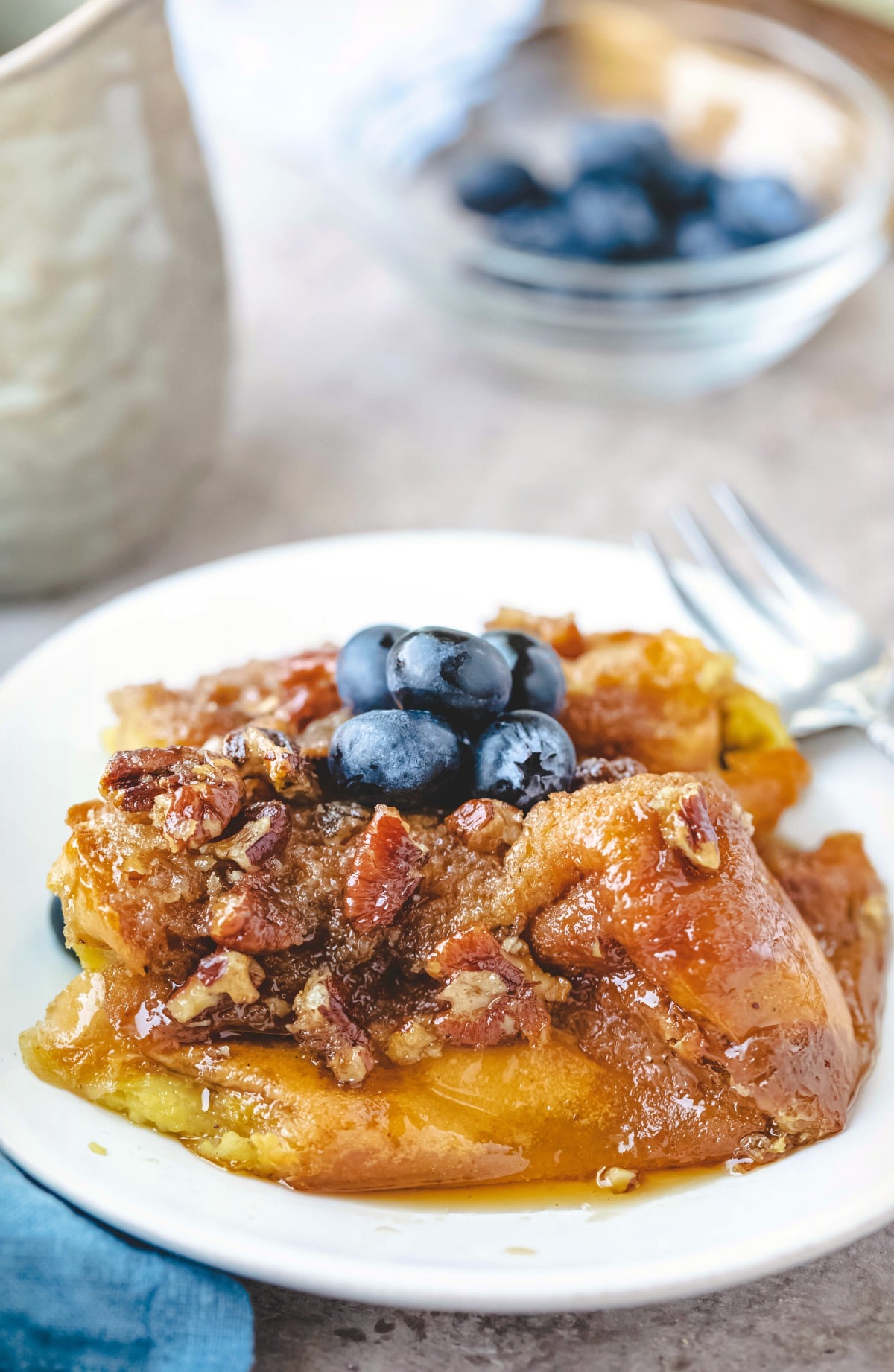 White plate with praline french toast and a fork on it