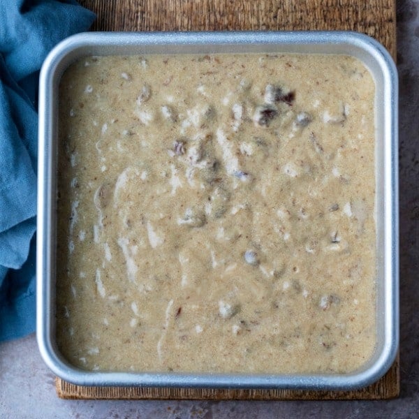 Unbaked sticky toffee pudding cake in a metal baking pan