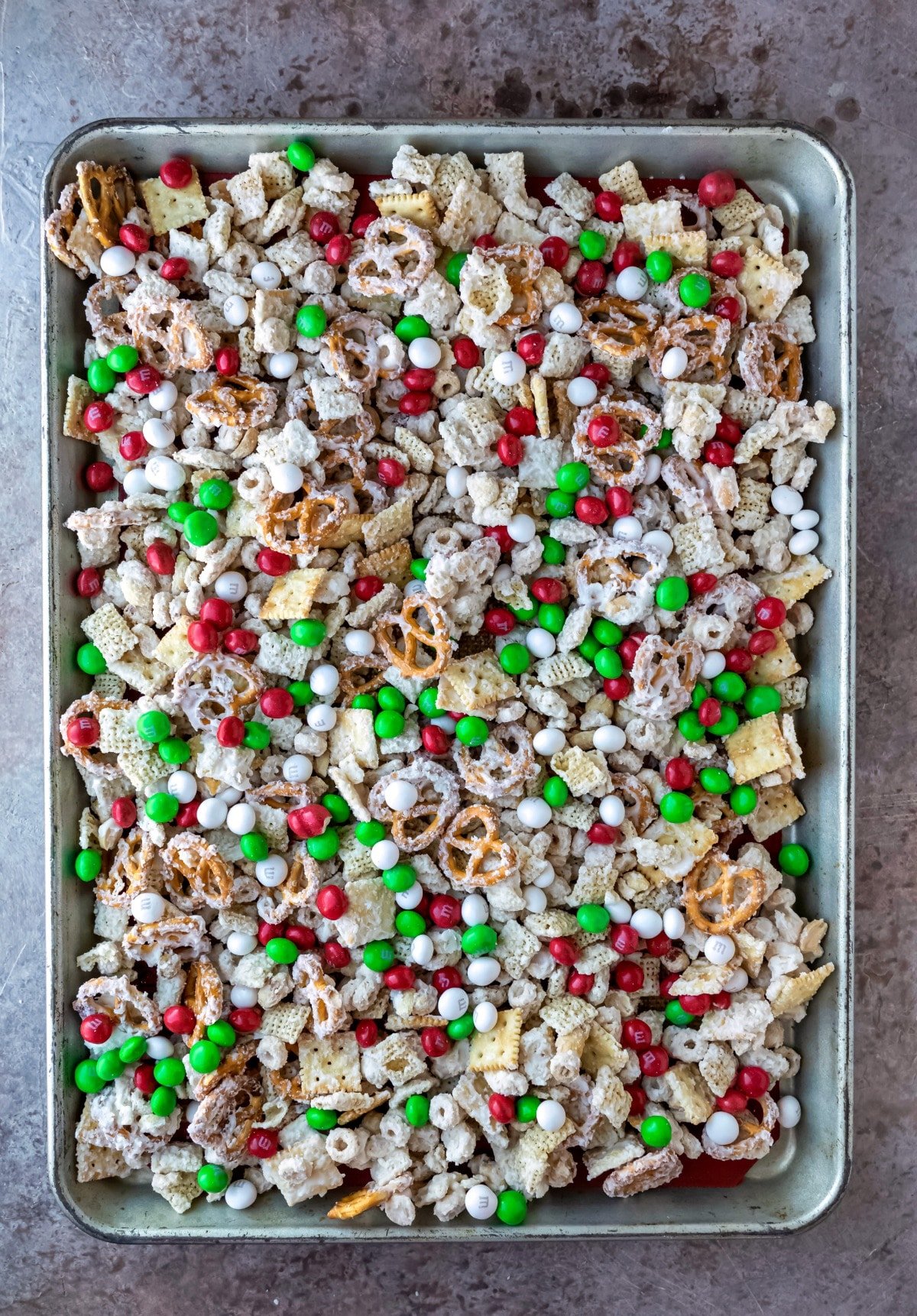 White chocolate party mix on a rimmed baking sheet