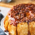 Easy overnight sticky buns on a white scalloped platter