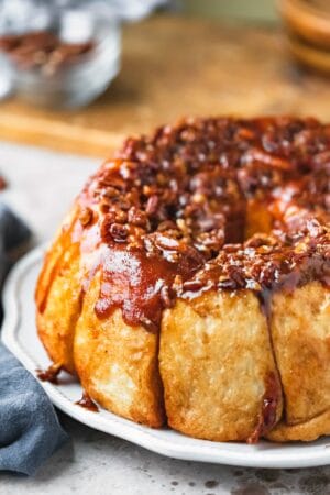 Easy overnight sticky buns on a white scalloped platter