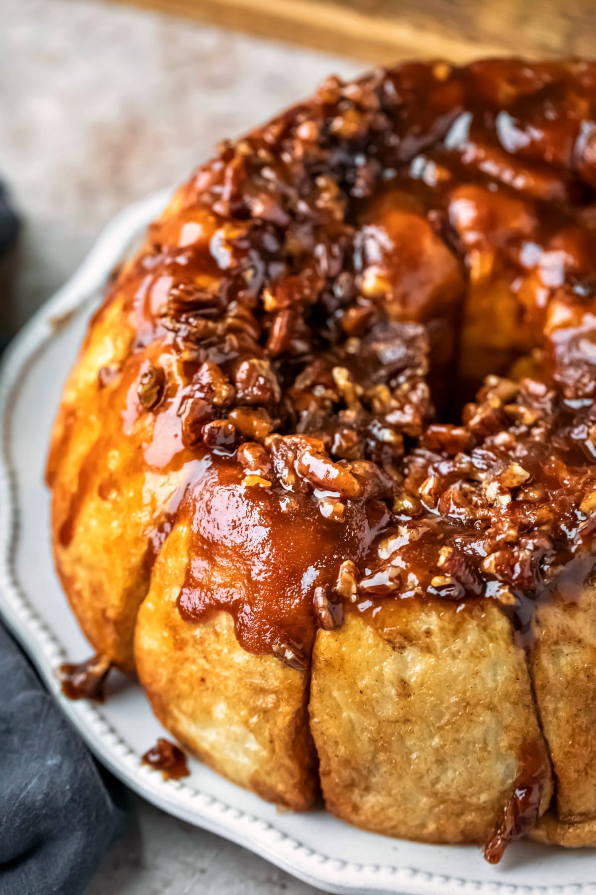 plate of easy overnight sticky buns next to a blue linen napkin