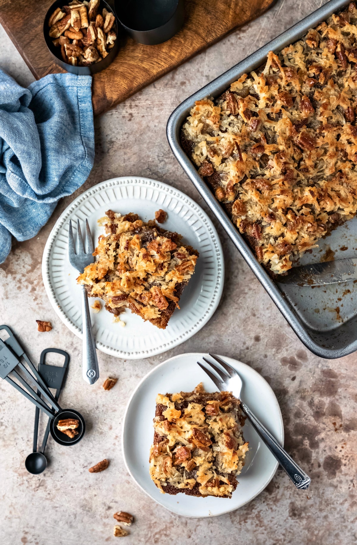 Two plates with pieces of oatmeal cake next to the pan of cake