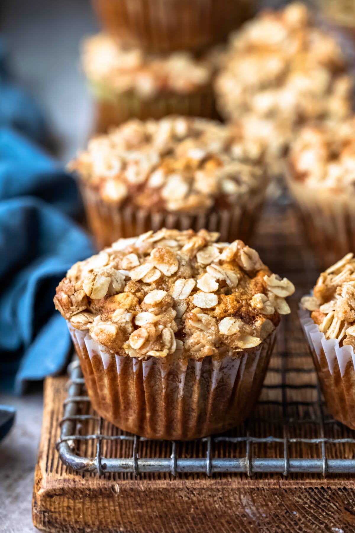 Row of banana oatmeal muffins next to a blue linen napkin