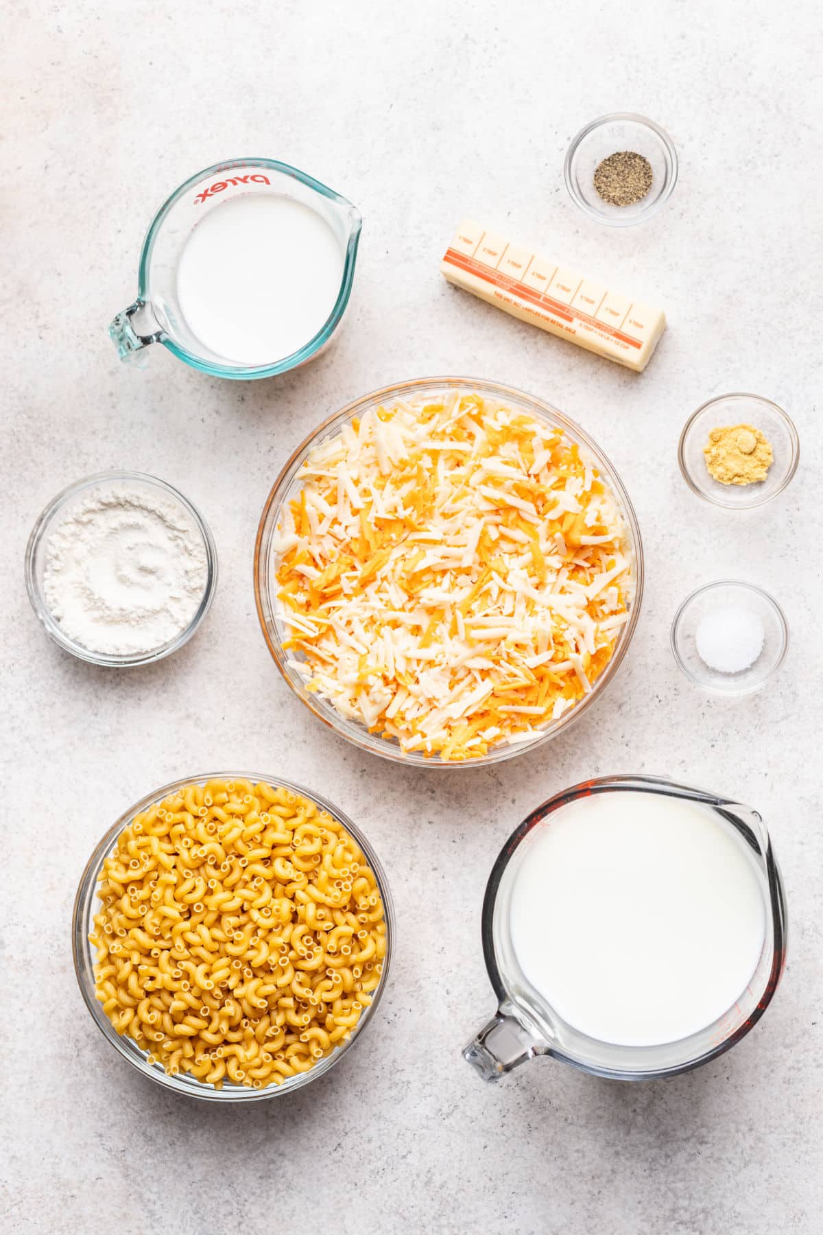 Ingredients for baked mac and cheese in dishes.