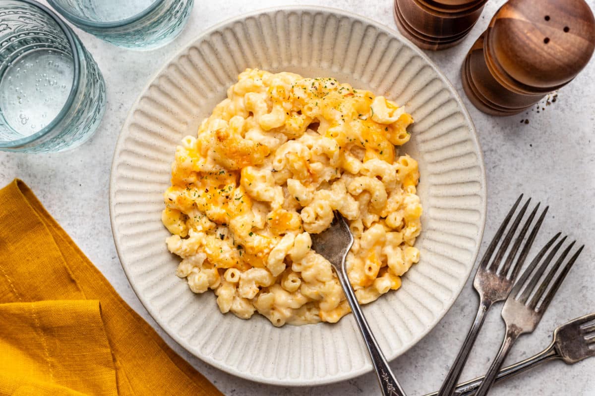 Baked Mac and Cheese Recipe A plate of baked mac and cheese with a fork in it.