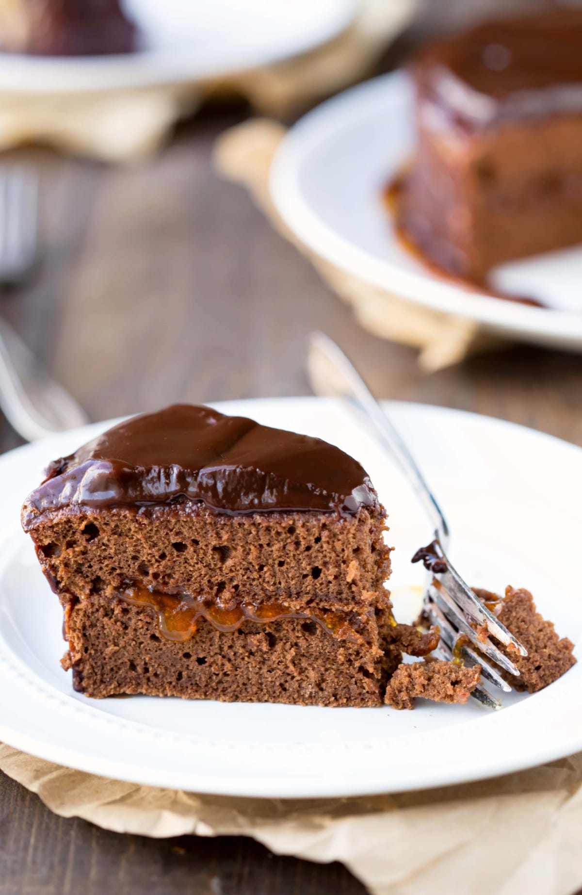 Sacher Torte slice on a white plate with a fork