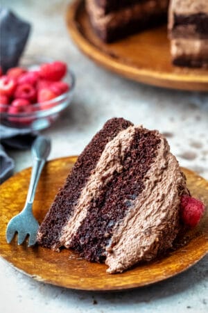 Slice of chocolate brownie cake on a wooden plate
