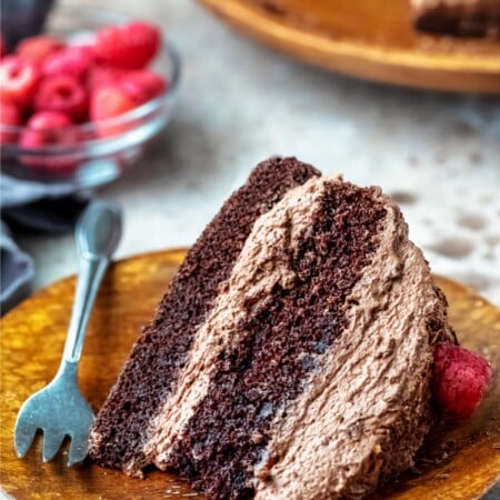 Slice of chocolate brownie cake on a wooden plate