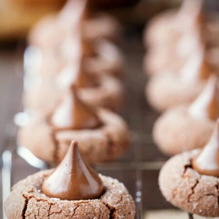 Chocolate Kiss Cookies on a wire cooling rack over a piece of parchment paper