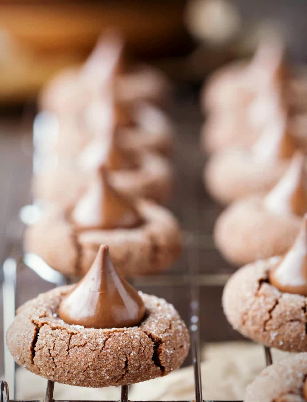 Chocolate Kiss Cookies on a wire cooling rack over a piece of parchment paper