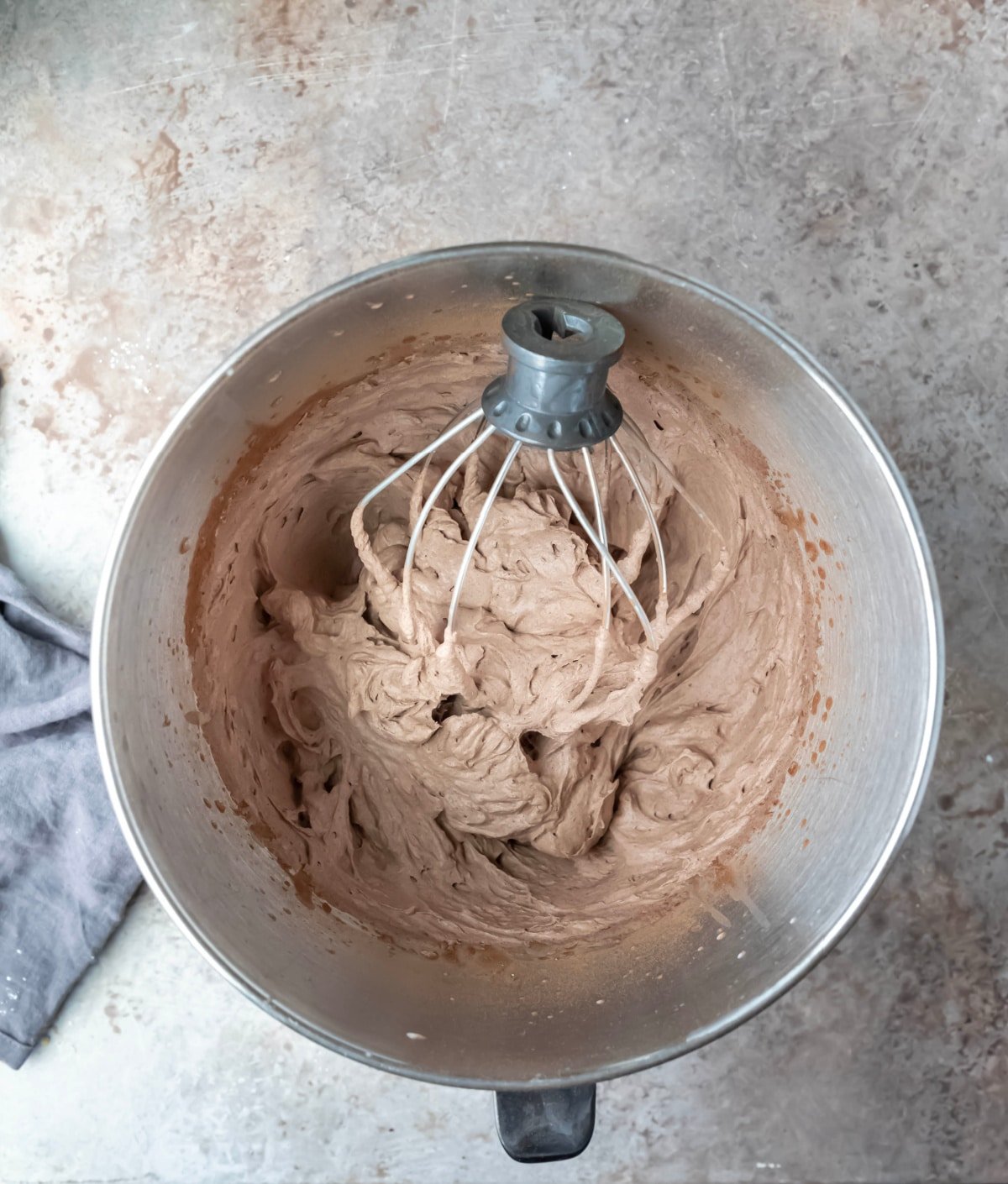 chocolate whipped cream in a silver mixing bowl