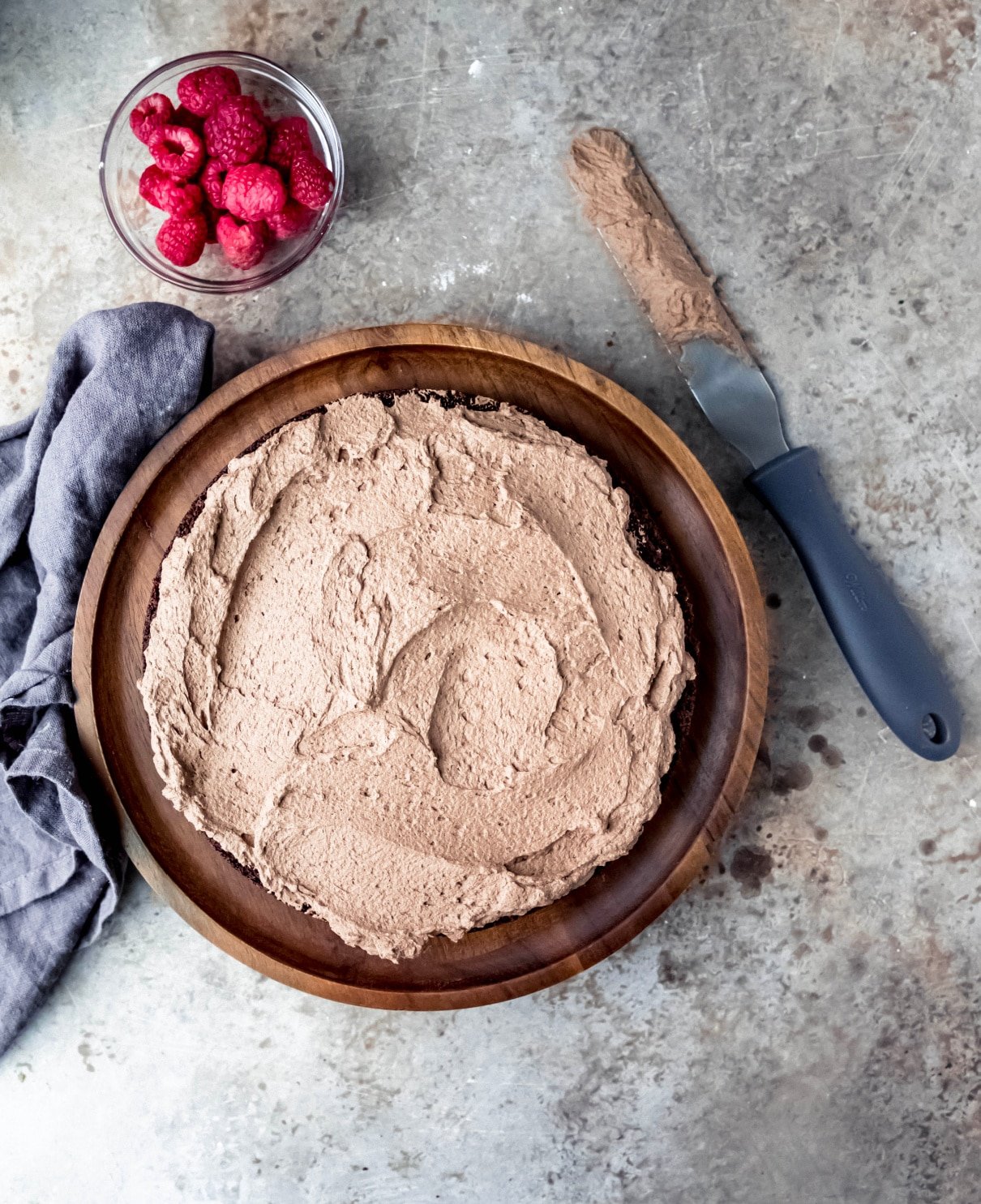 chocolate whipped cream spread onto a chocolate cake