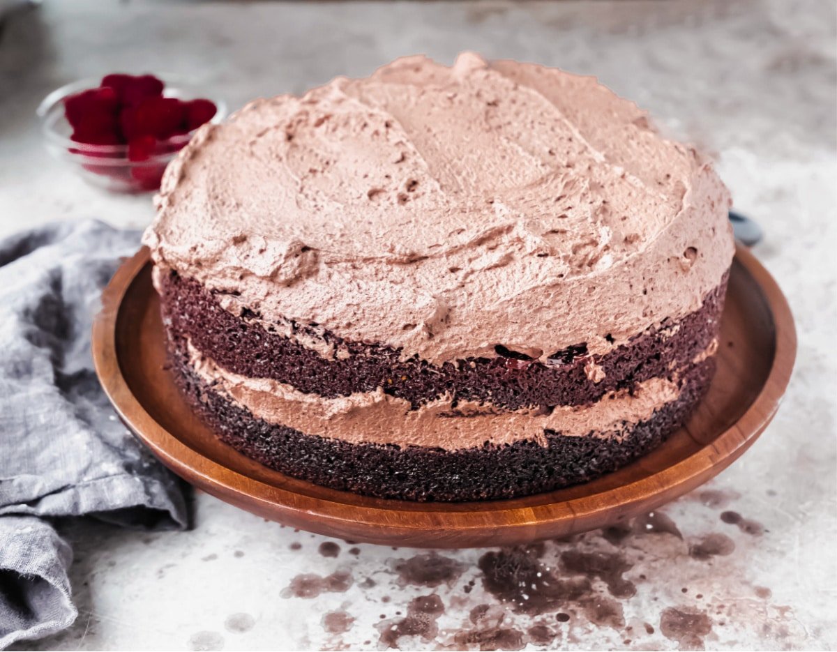 chocolate whipped cream frosted on a chocolate layer cake