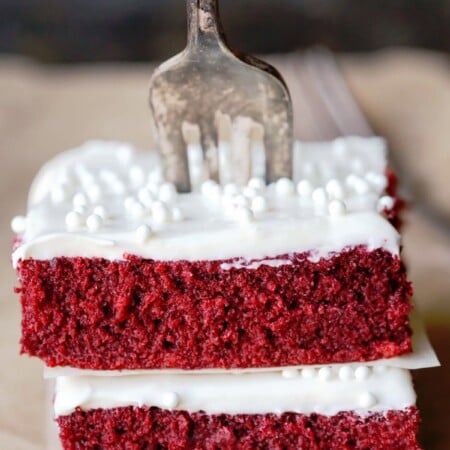 Red velvet sheet cake pieces with a fork in them