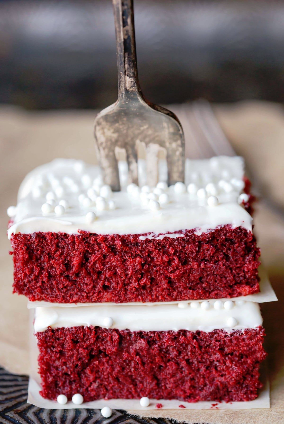 Red velvet sheet cake pieces with a fork in them