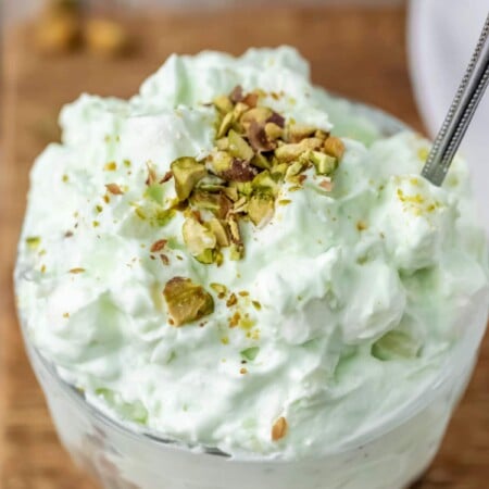 Dish of watergate salad topped with chopped nuts