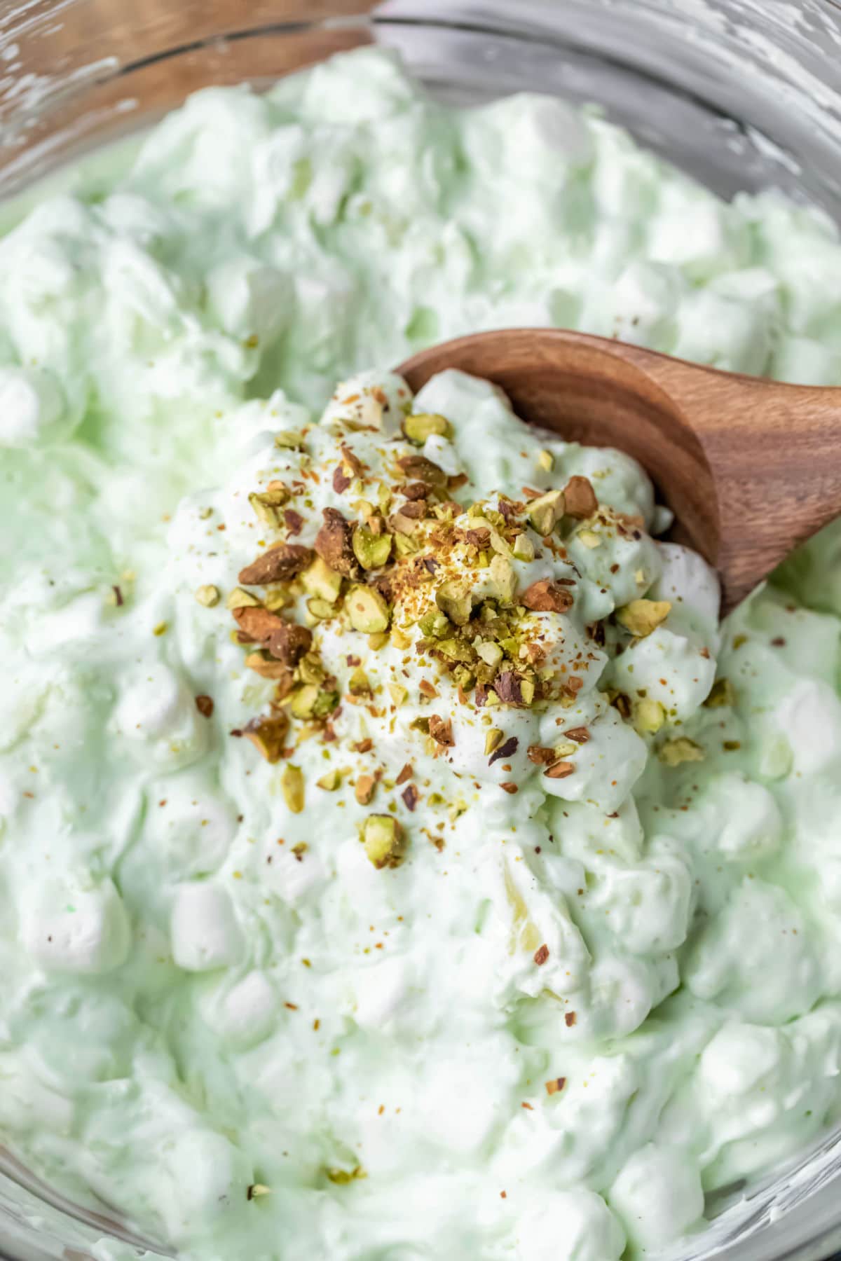 Wooden spoon scooping up watergate salad