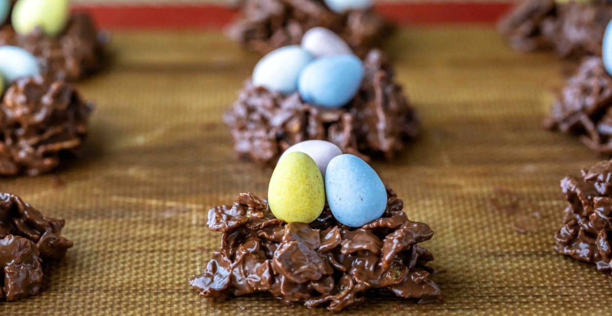 chocolate bird's nest cookies on a silicone baking mat.