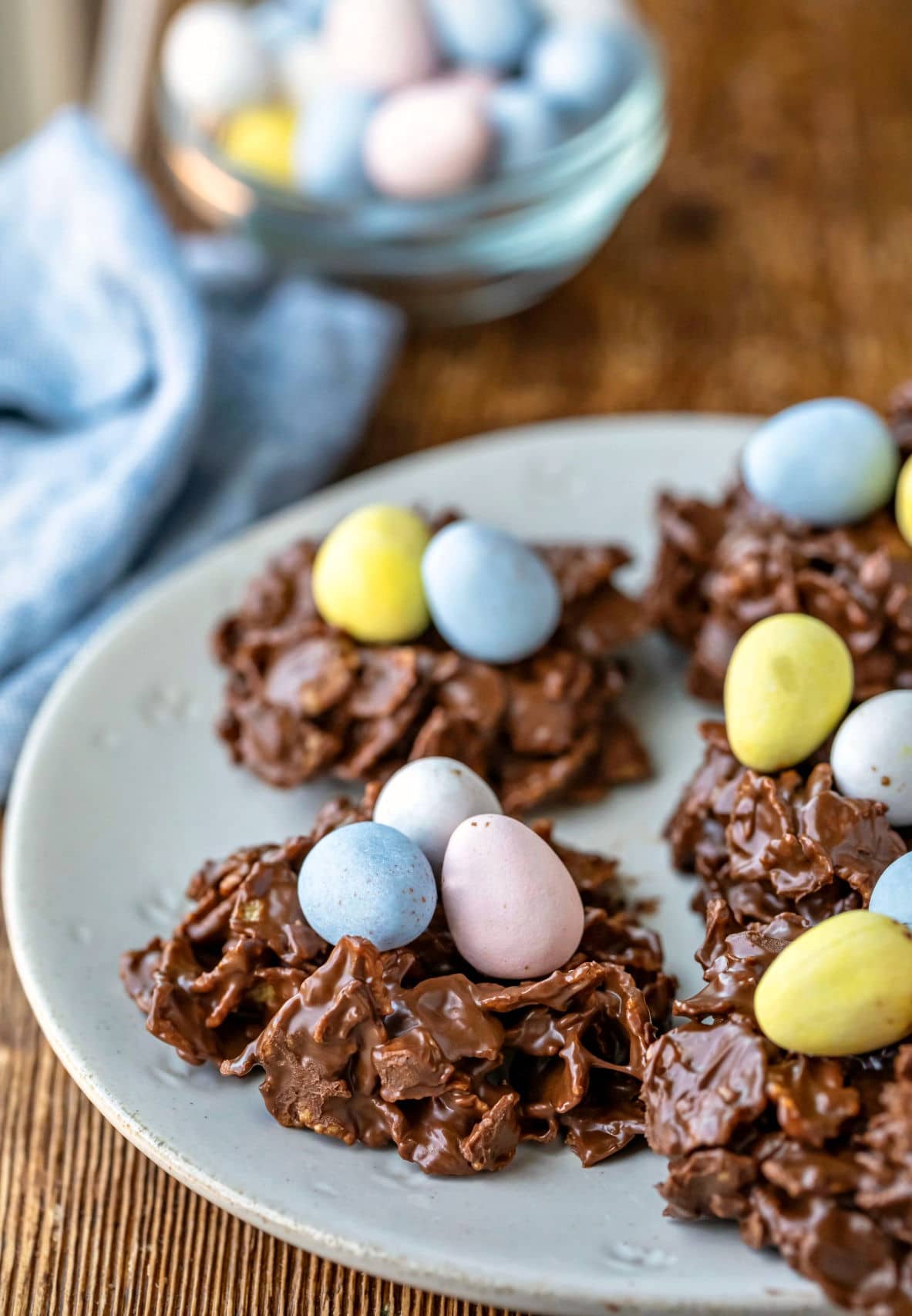 Plate of bird's nest cookies topped with mini eggs.
