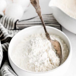 Silver spoon in a bowl of cake flour.