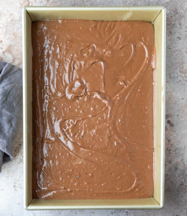 Chocolate mashed potato cake batter in a baking pan.