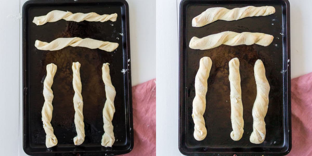 Baked and unbaked breadsticks on a metal baking pan.