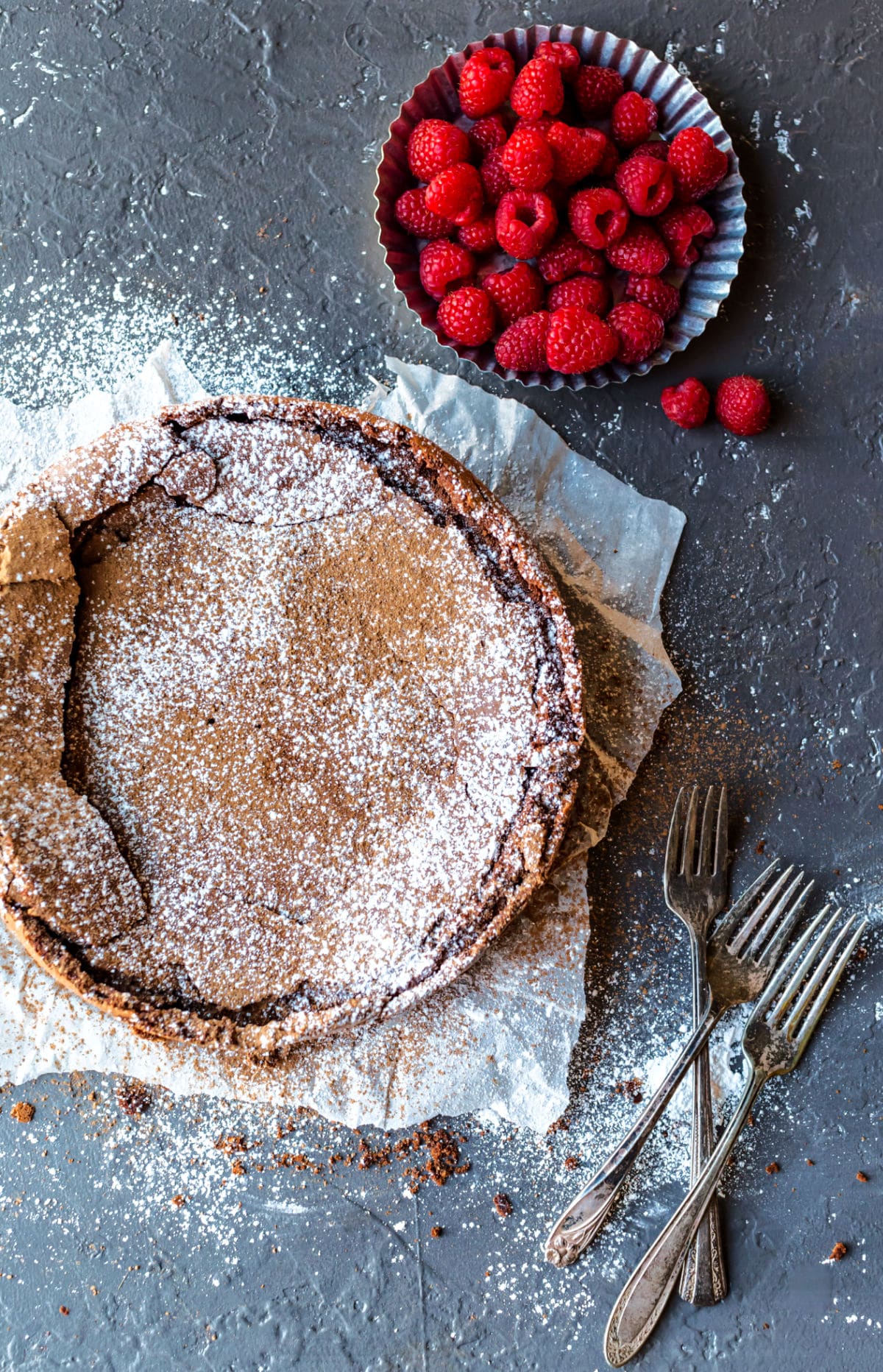 Flourless chocolate cake dusted with cocoa powder and powdered sugar. 