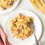 Slow cooker scalloped potatoes with ham on a white plate.