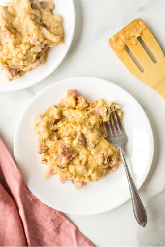 Slow cooker scalloped potatoes with ham on a white plate.