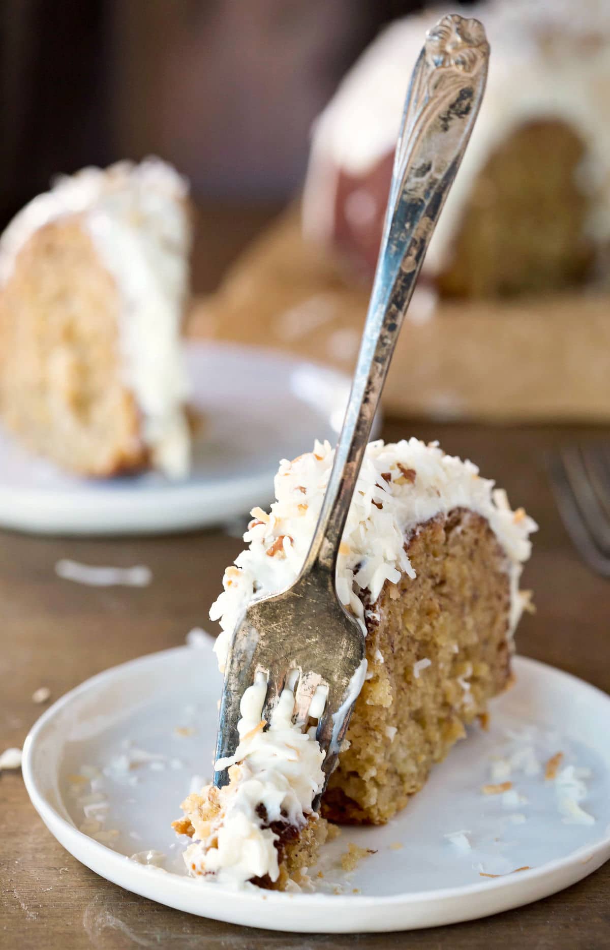 A fork taking a bite of hummingbird bundt cake.