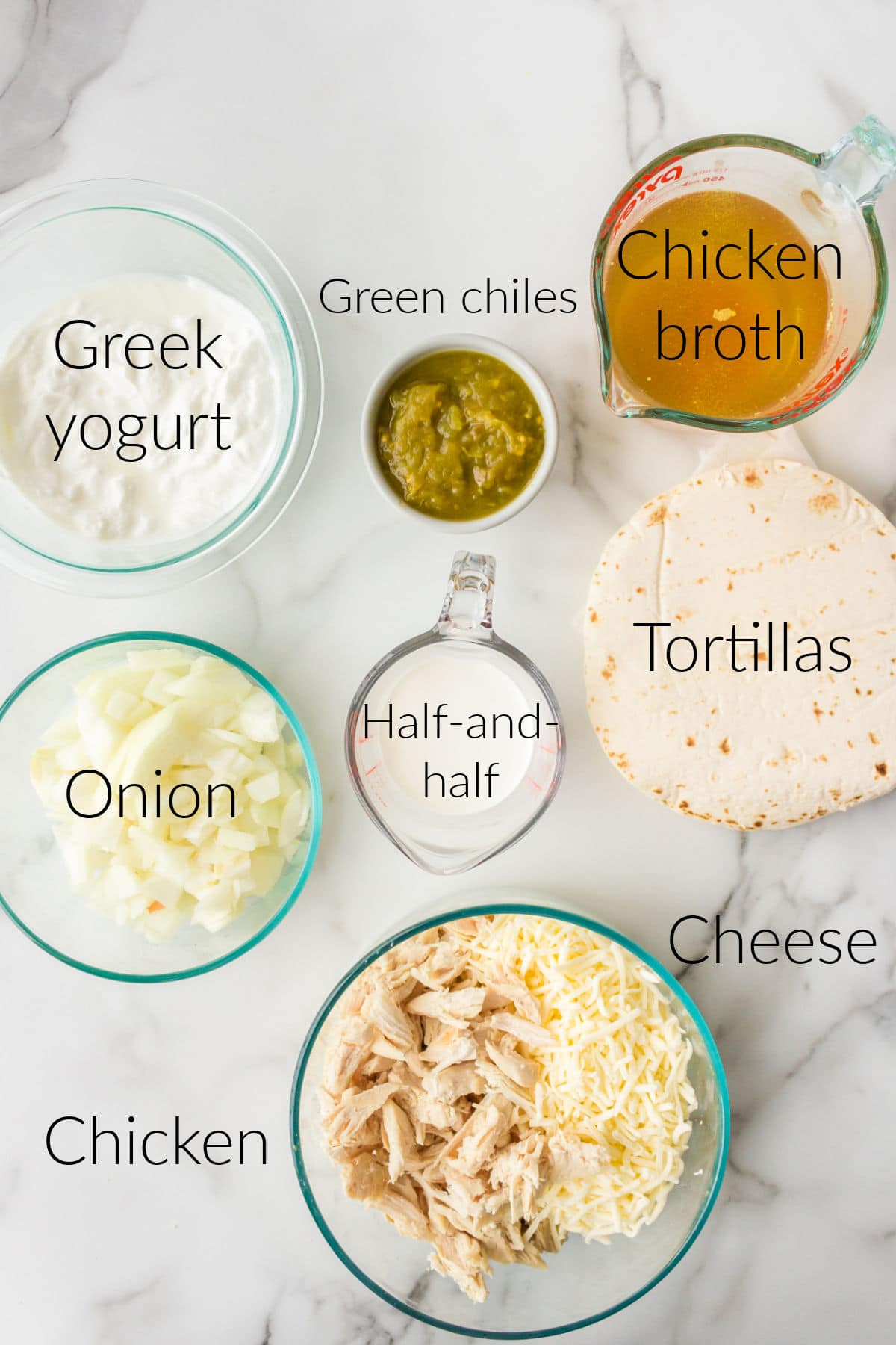 White chicken enchilada ingredients in bowls with labels on the photo.