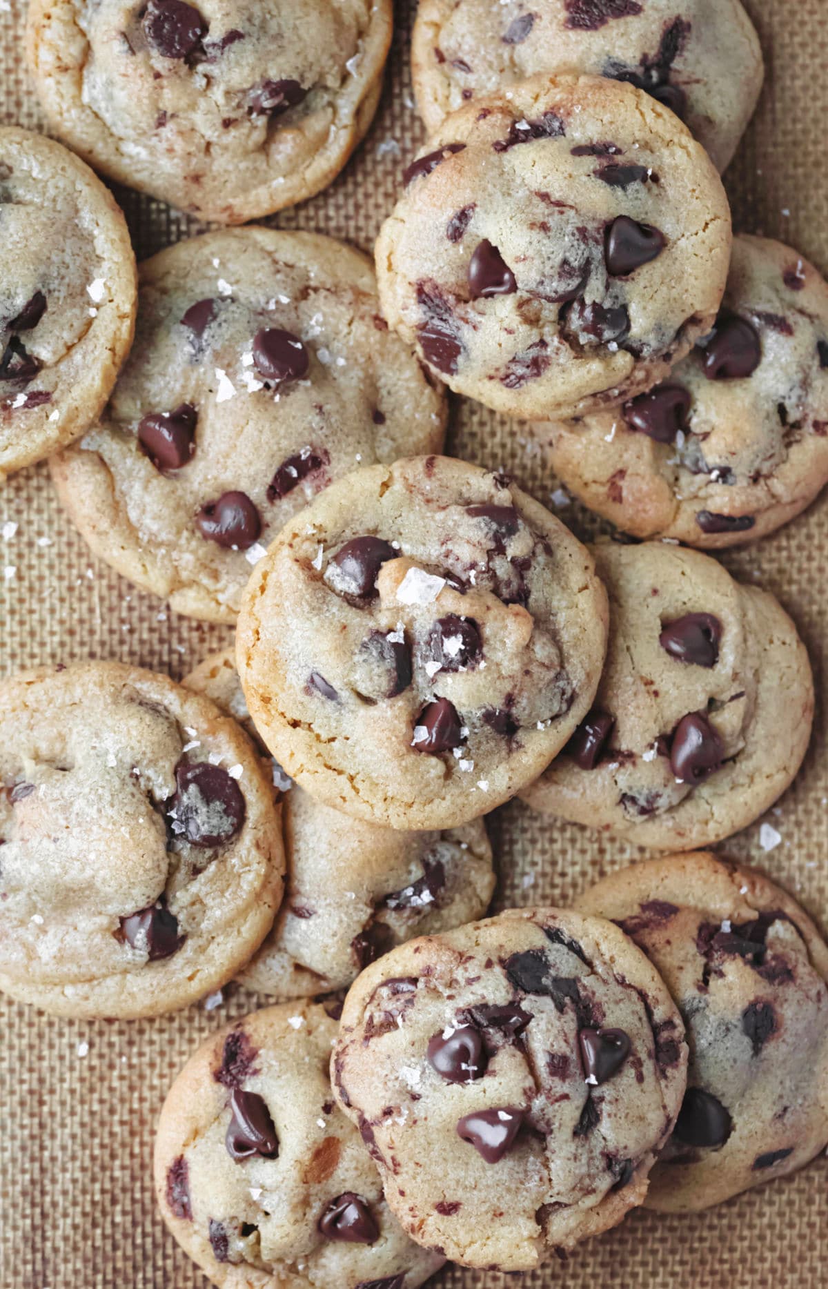 Stack of brown butter chocolate chip cookies topped with sea salt. 