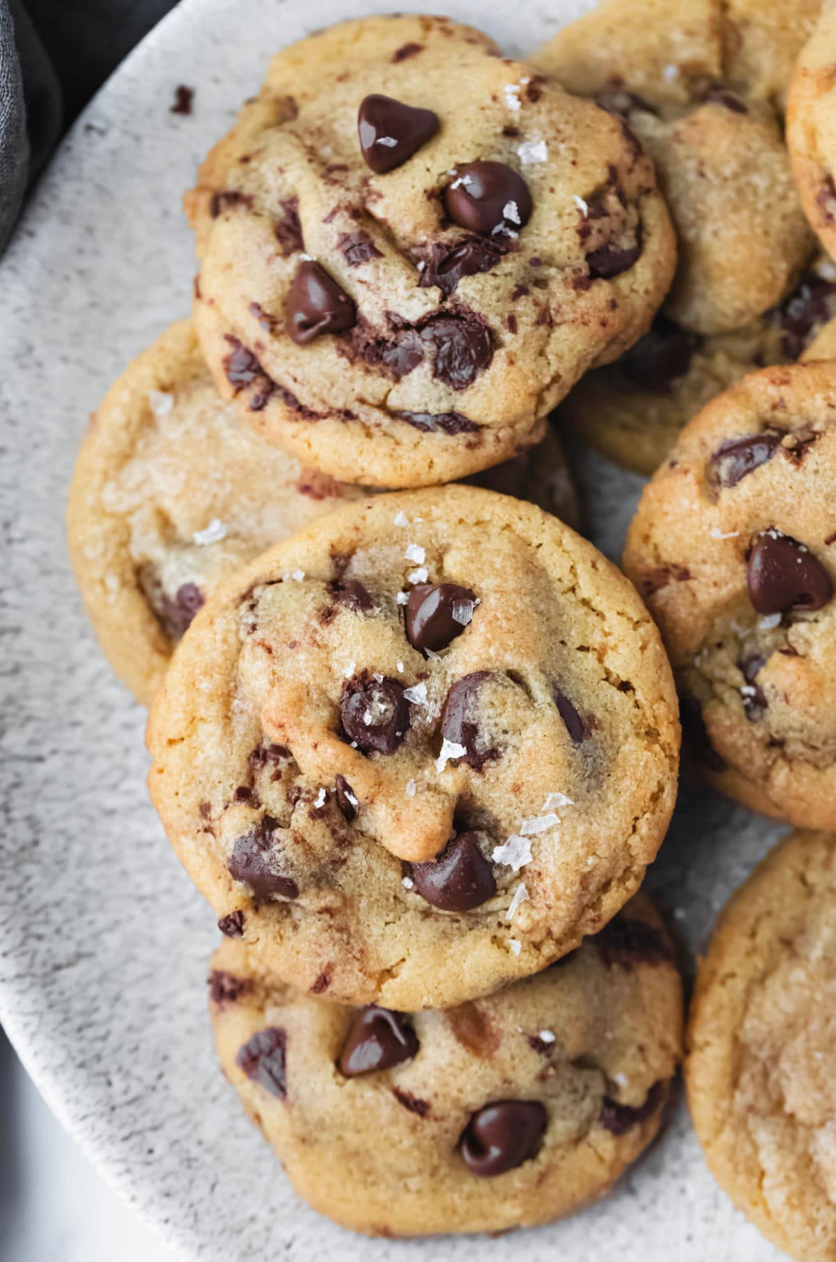 Brown butter chocolate chip cookies stacked on a plate. 