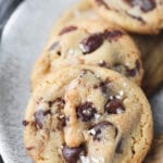 Brown butter chocolate chip cookies lined up on a plate.