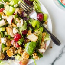 Waldorf salad on a white plate on a marble background