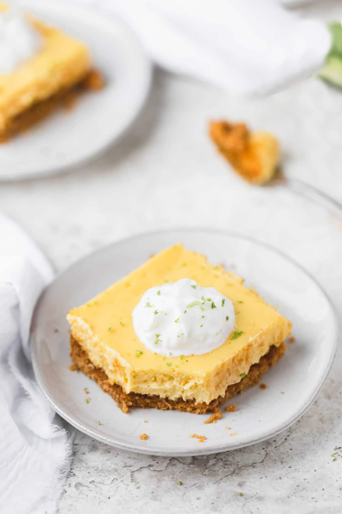 Overhead photo of key lime pie bars on white plate. 