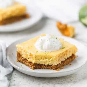 Square photo of key lime pie bar on a white plate.