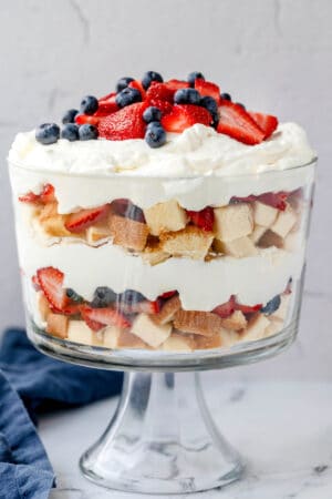 Layers of pound cake whipped cream and fresh berries in a trifle dish.