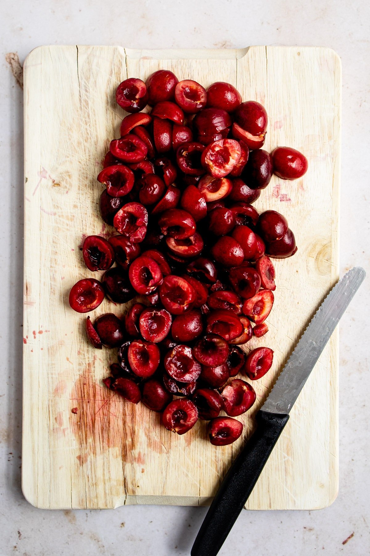Fresh cherries on a wooden cutting board.