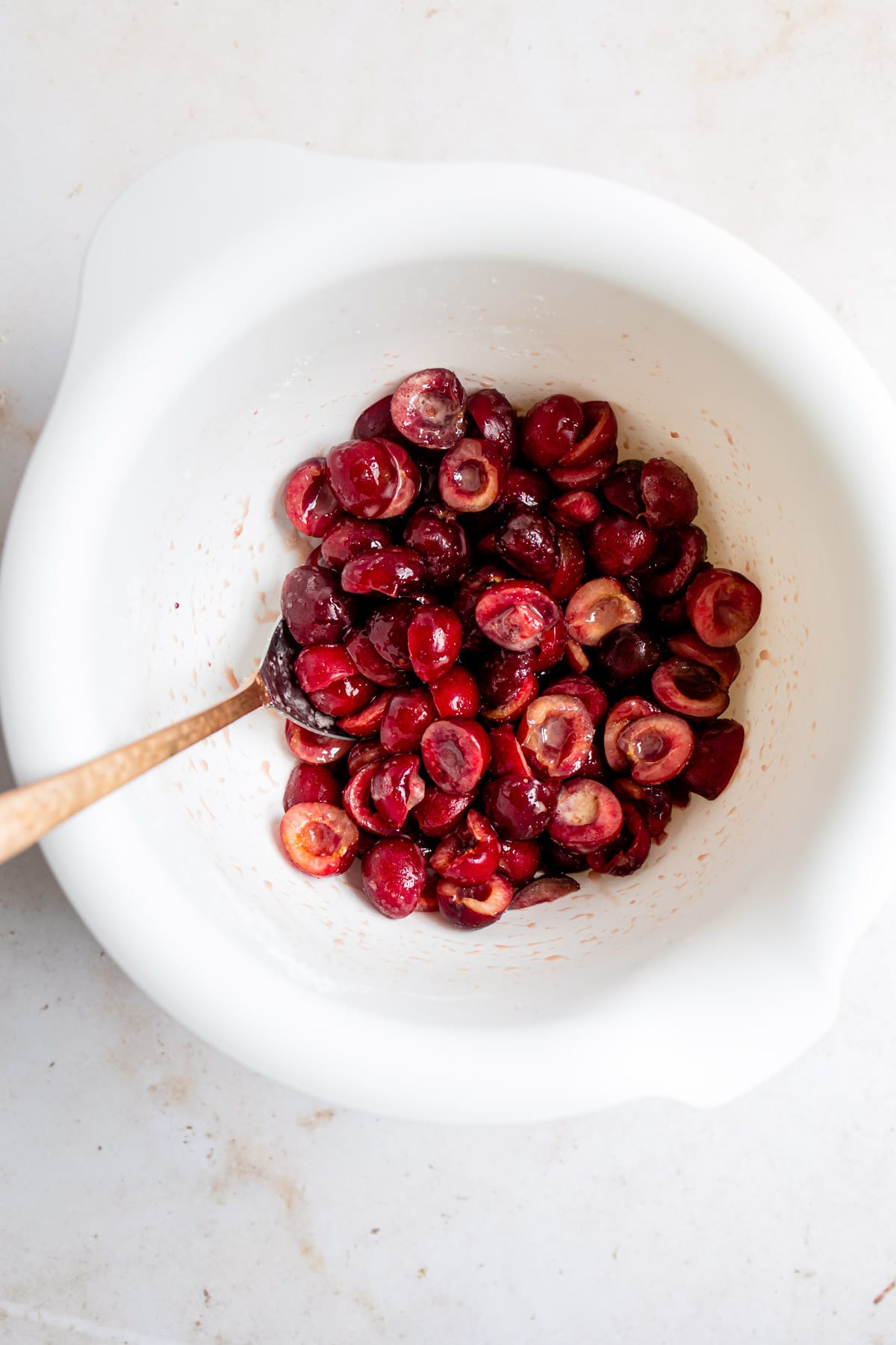 Cherry filling in a white mixing bowl. 