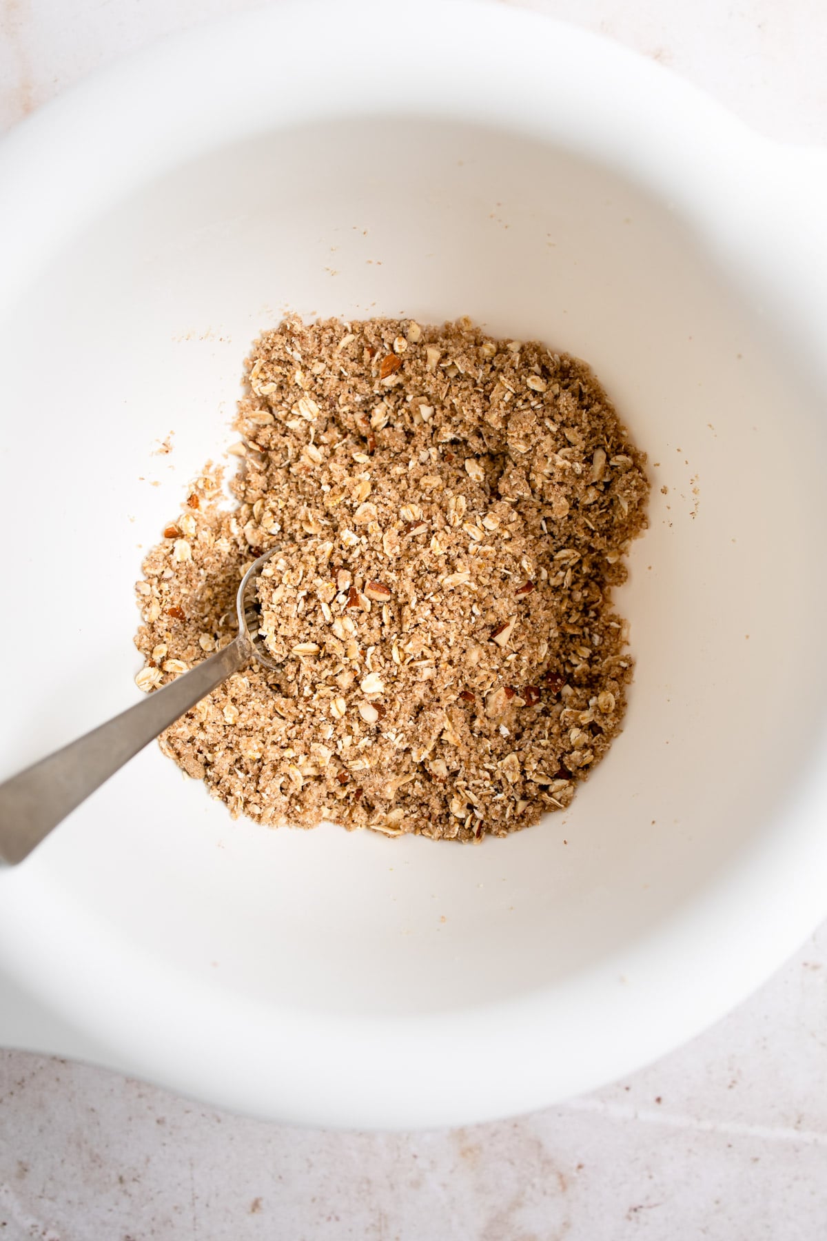 Mixed crisp topping in a white mixing bowl. 