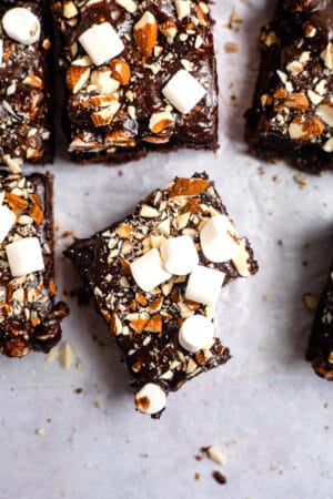 Slice of rocky road sheet cake with a bite out of it.