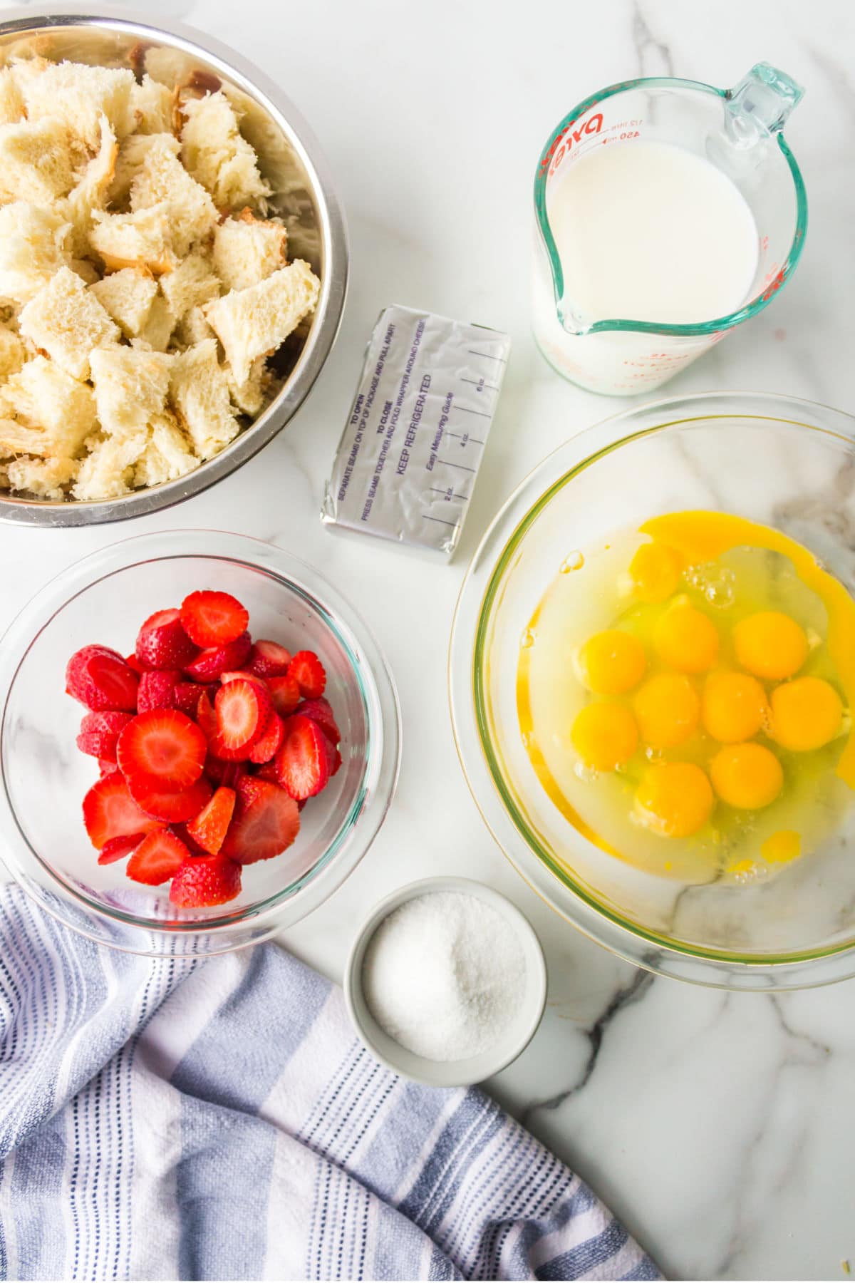 Ingredients for strawberry cream cheese french toast in bowls.