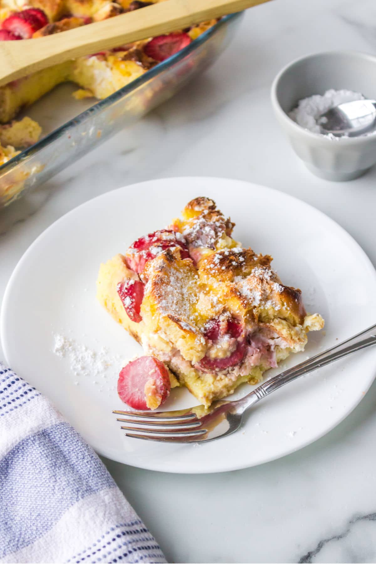 Slice of strawberry cream french toast on a white plate. 