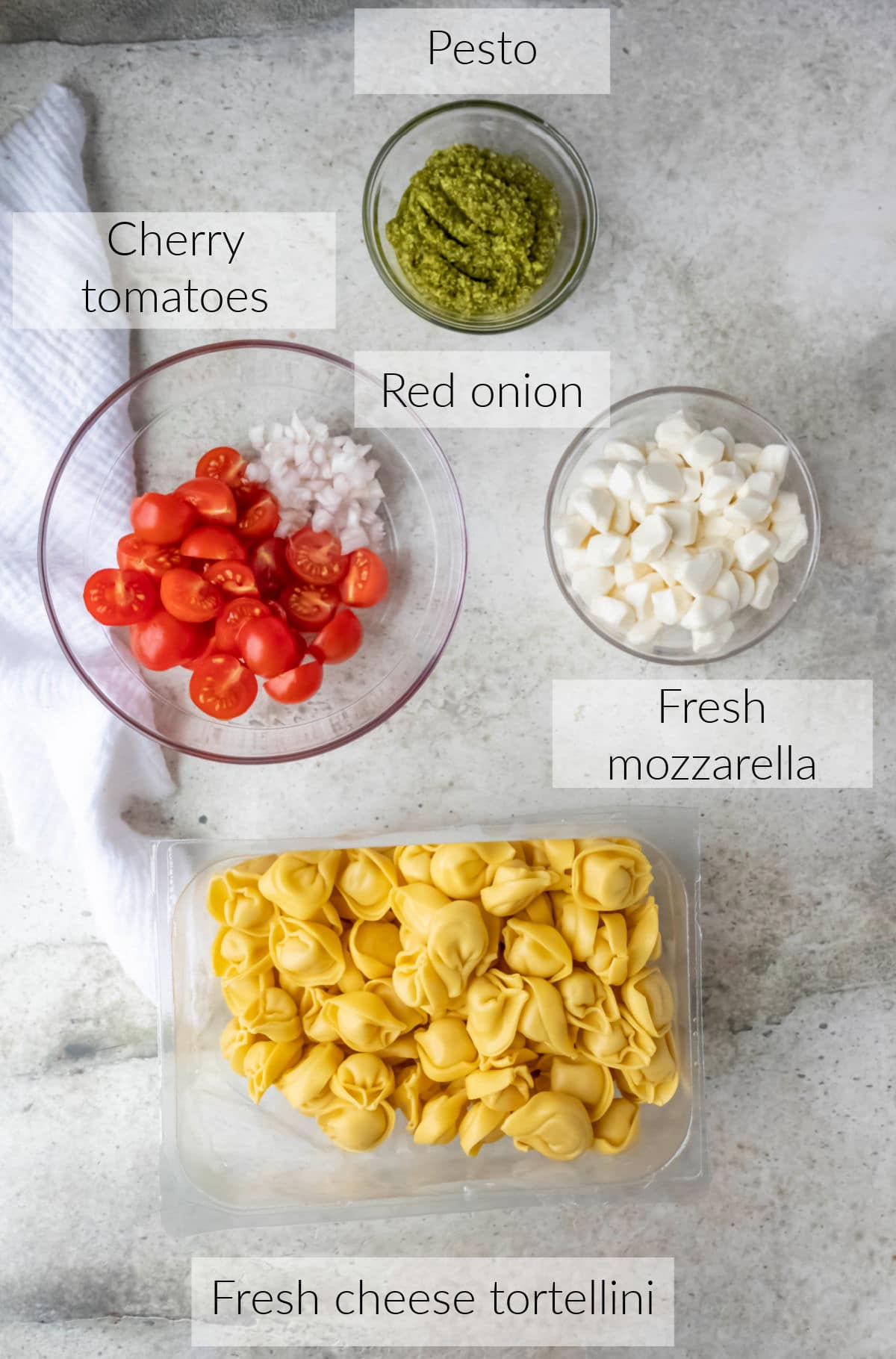 Labeled photo with pesto tortellini ingredients in dishes.