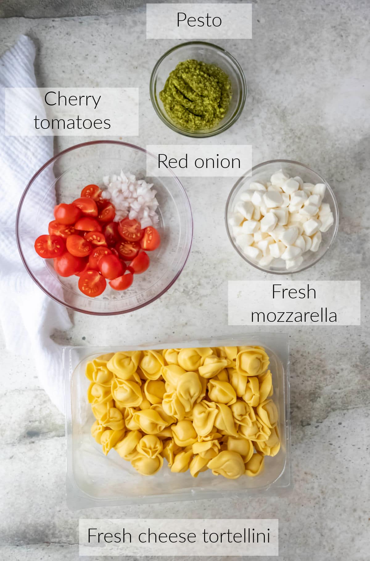 Labeled photo with pesto tortellini ingredients in dishes. 