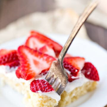 Fork taking a bite of strawberry shortcake bar.