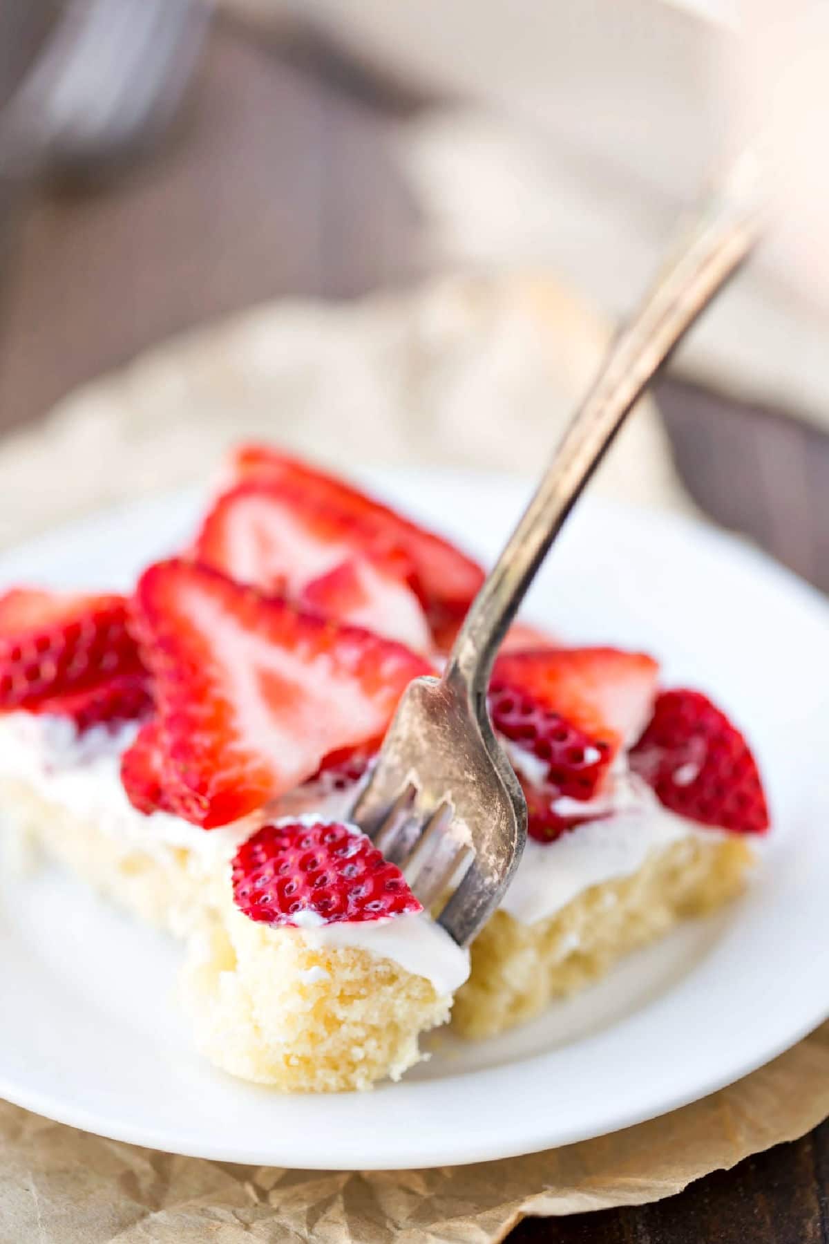 Fork taking a bite of strawberry shortcake bar.