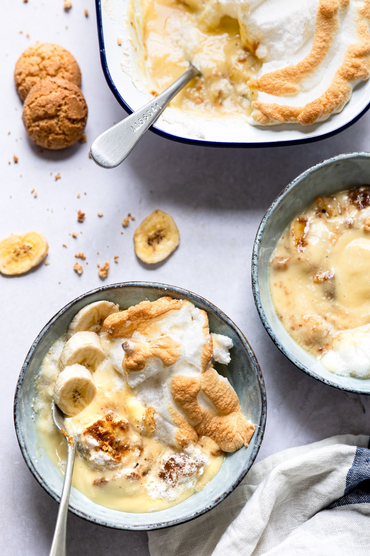 Dish of banana pudding with a spoon in it. 
